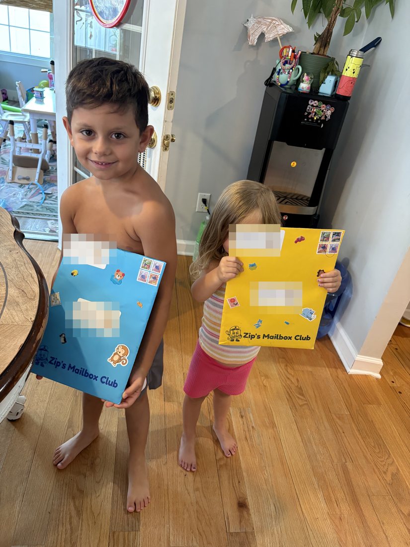 A brother and sister each holding their own colorful envelope from Zip